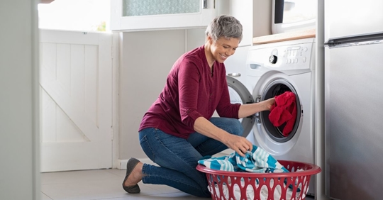 woman taking clothes out of the dryer