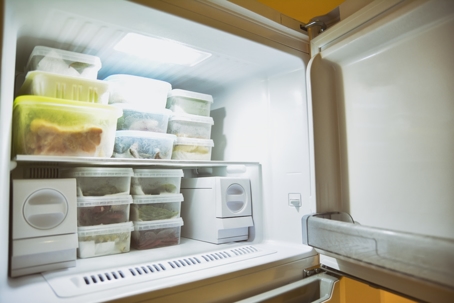 organized freezer full of frozen food in containers